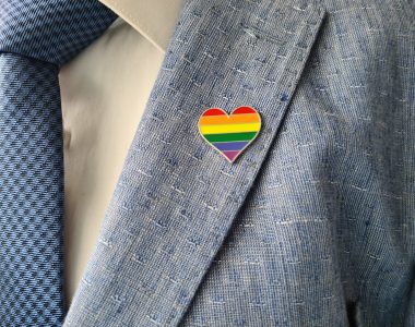 Businessman in a suit with sign of LGBT and lesbian gay bisexual and transgender people
