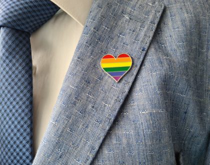 Businessman in a suit with sign of LGBT and lesbian gay bisexual and transgender people