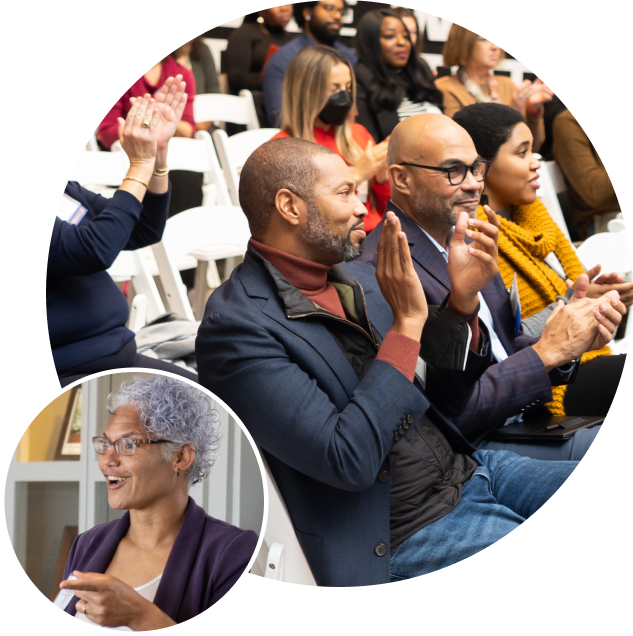 Photo of people in audience cheering and woman speaking